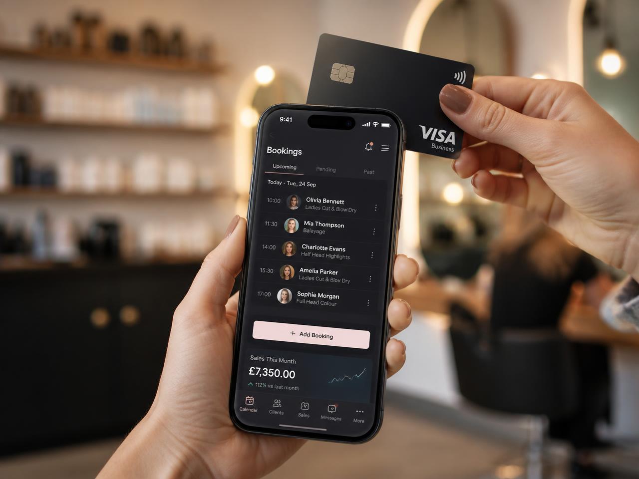 A stylist taking a contactless card payment on an iPhone showing the BookAppointment business diary